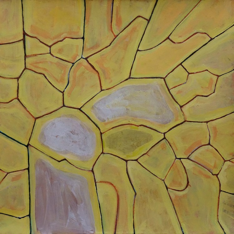 An abstract textured surface with a pattern of yellow/orange and dirty white shapes, (resembling cracked earth or stones.)